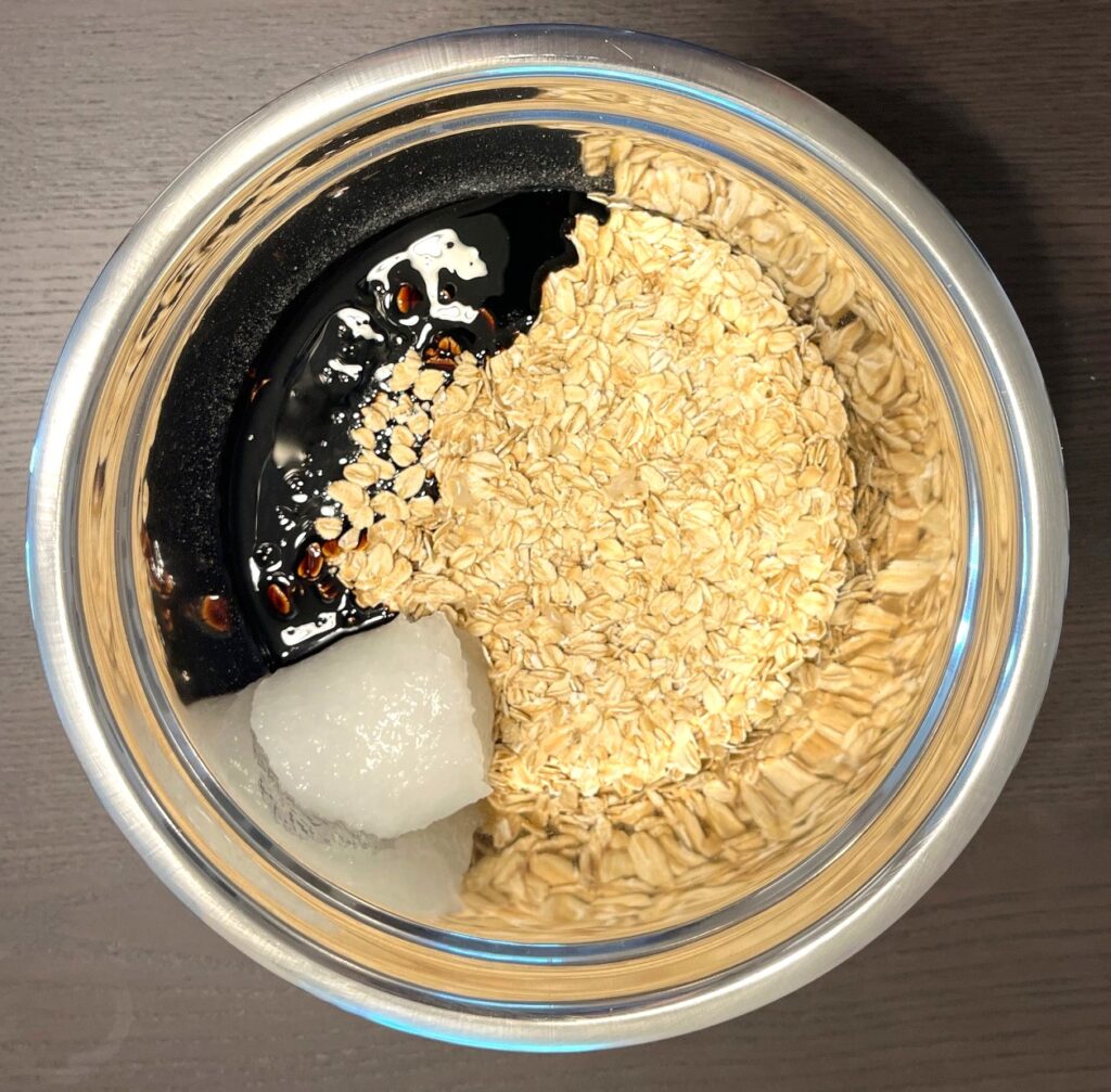 A bowl of oats and coconut oil and molasses