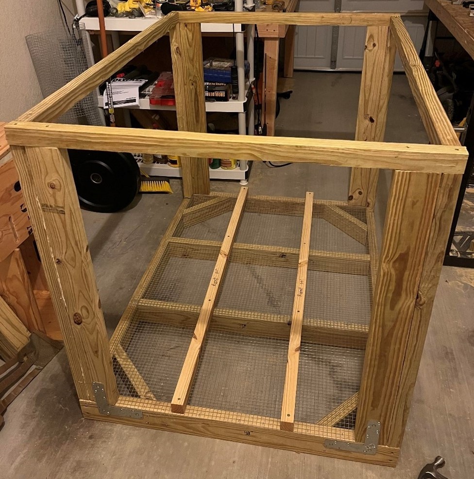 A wooden chicken coop frame