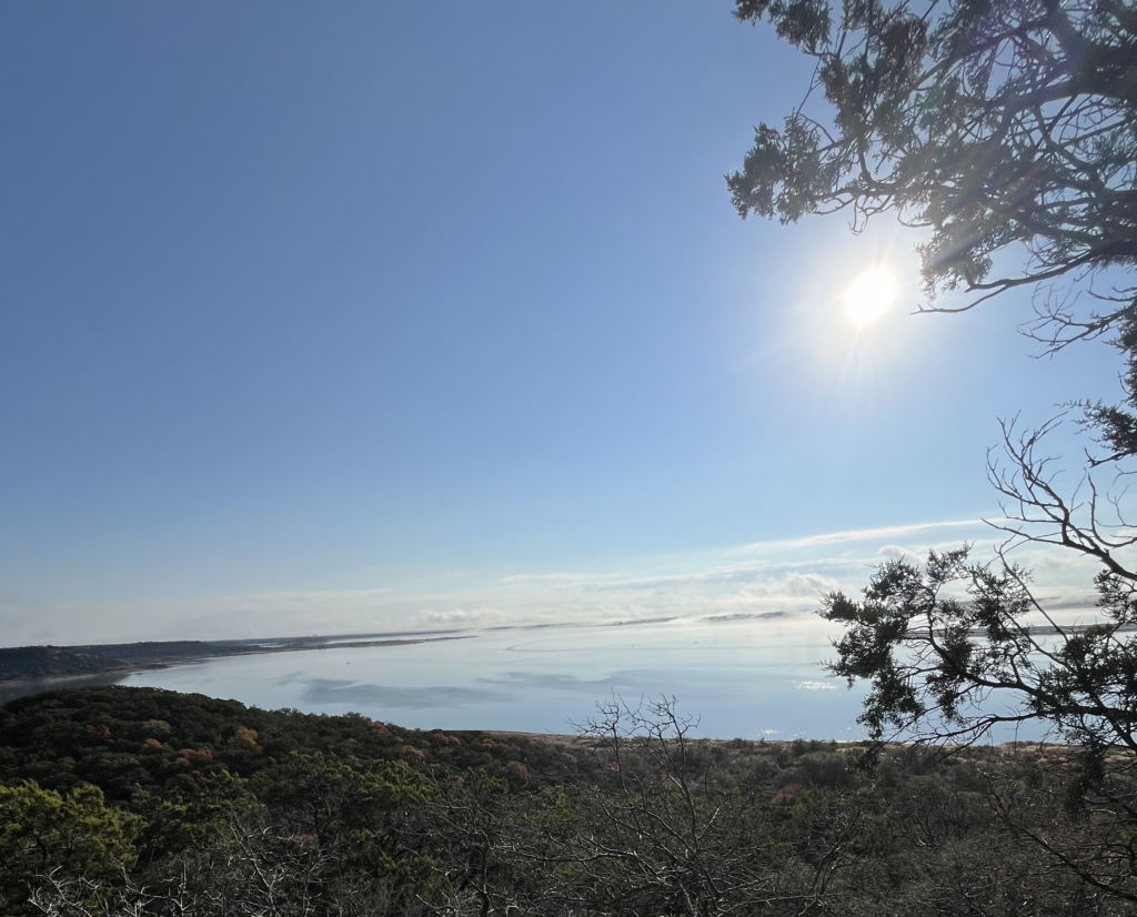 View of a lake in the sunshine from the top of a mountain. 